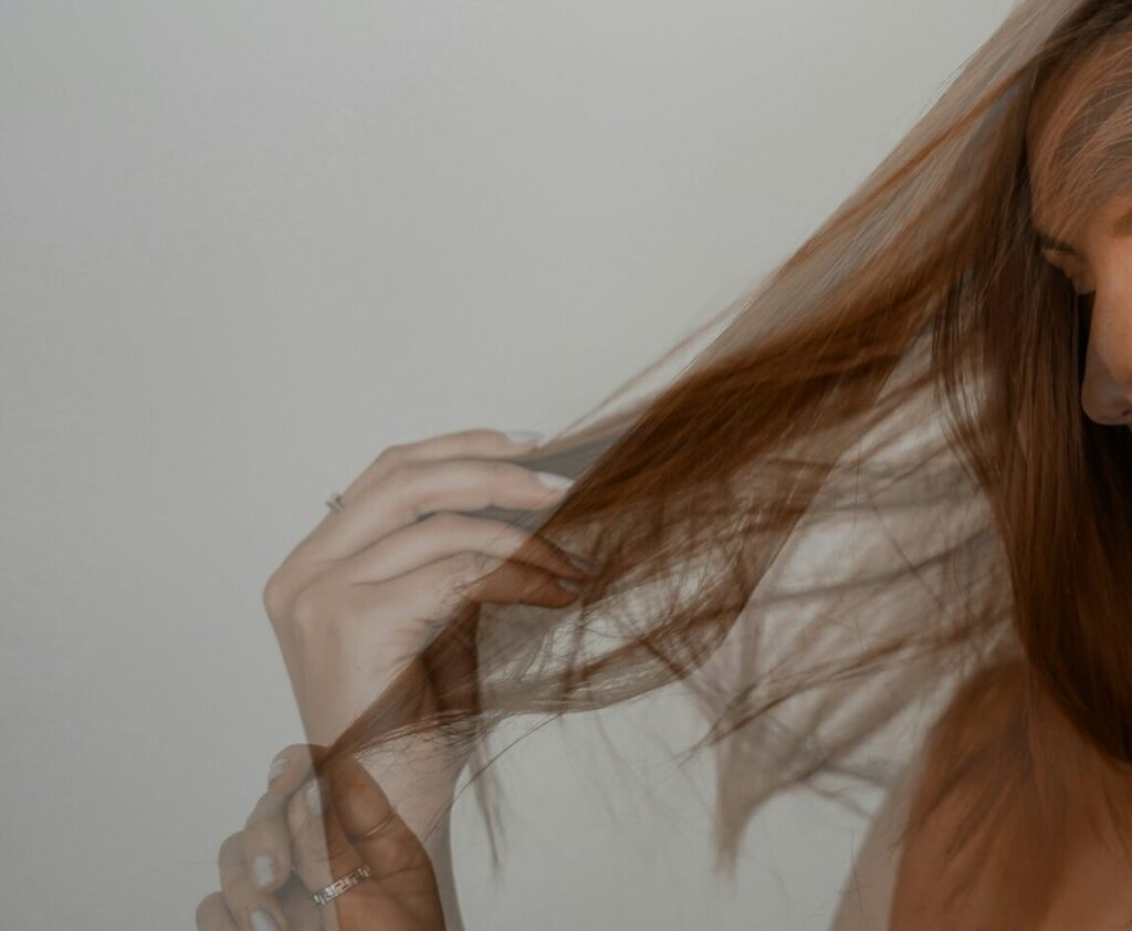 woman-long-hair-looking-down-thinning-concern