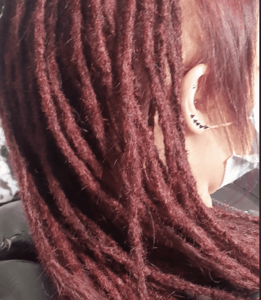 Dreadlock maintenance around a common high-friction area behind the ear