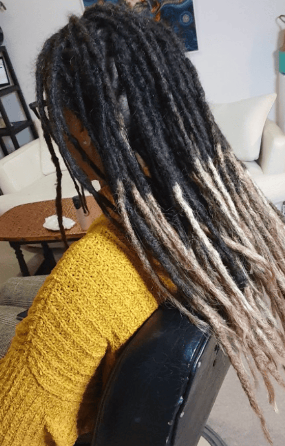 Permanent dreadlock extensions added to existing locs for natural-looking length