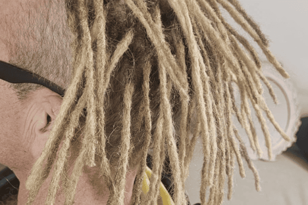 Permanent human hair dreadlock extensions showing a finished full-head result in the UK