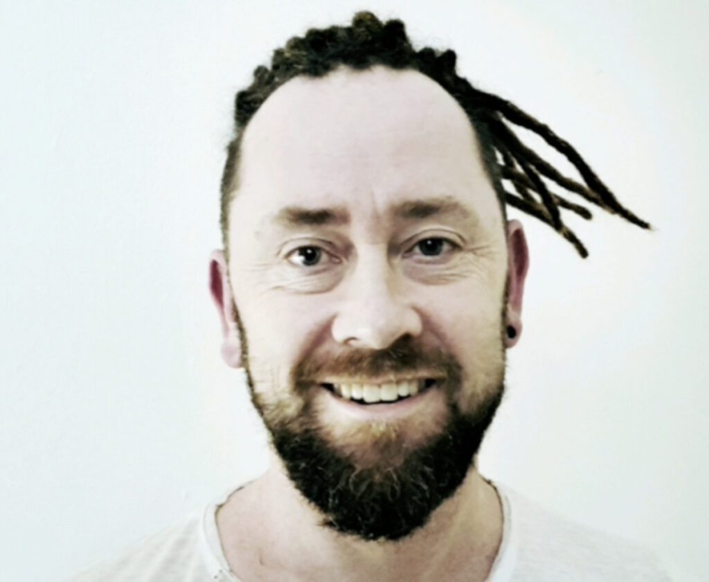 Front view of a client wearing permanent dreadlock extensions