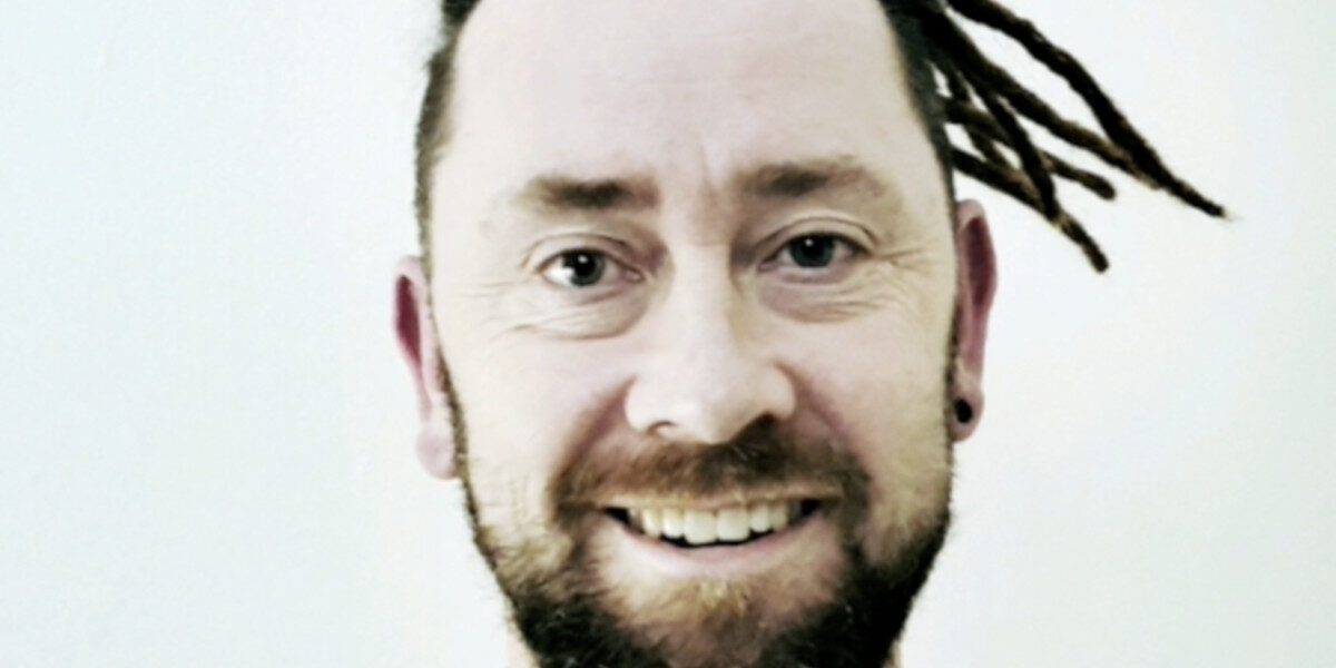 Front view of a client wearing permanent dreadlock extensions