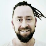 Front view of a client wearing permanent dreadlock extensions