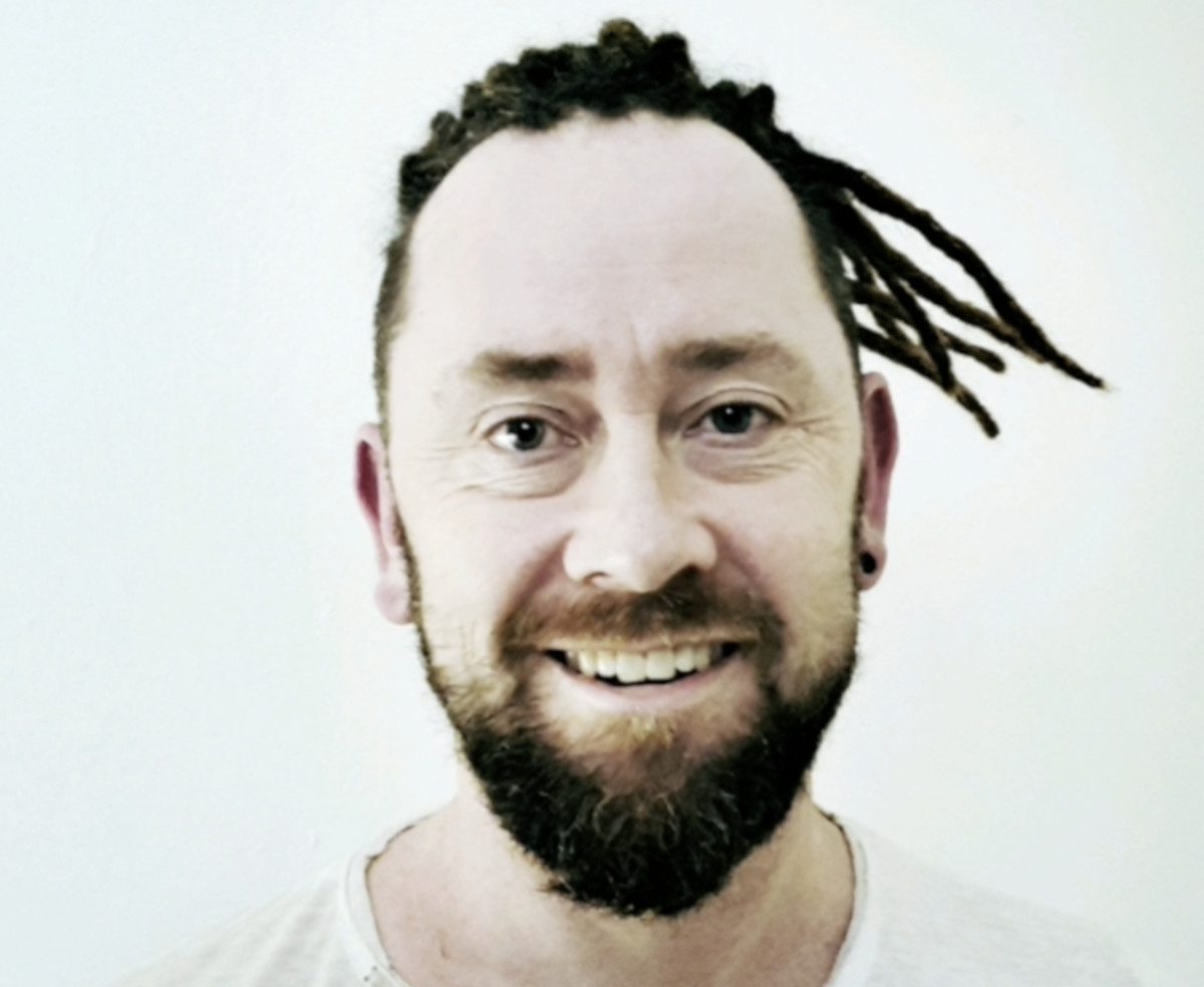 Front view of a client wearing permanent dreadlock extensions